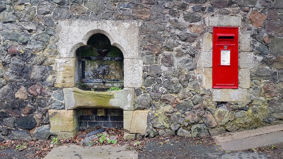 Malvern spring water well and postbox on Welland Road Malvern Worcestershire uk